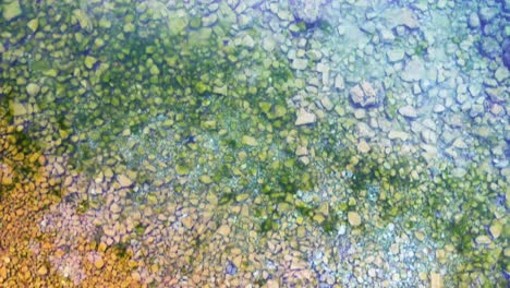 from shallow to deep drone shot of very clear water