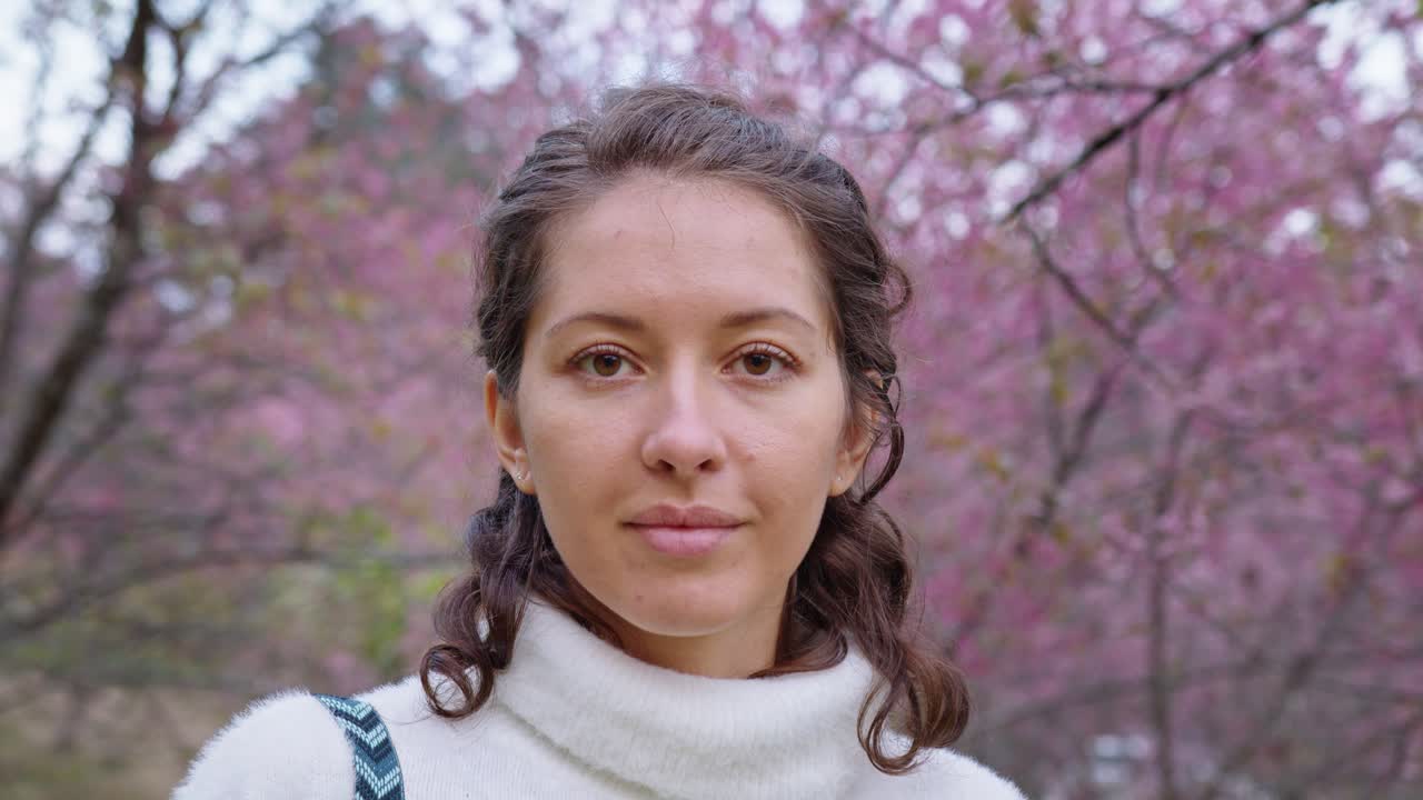 Woman in a Park Under Cherry Blossoms