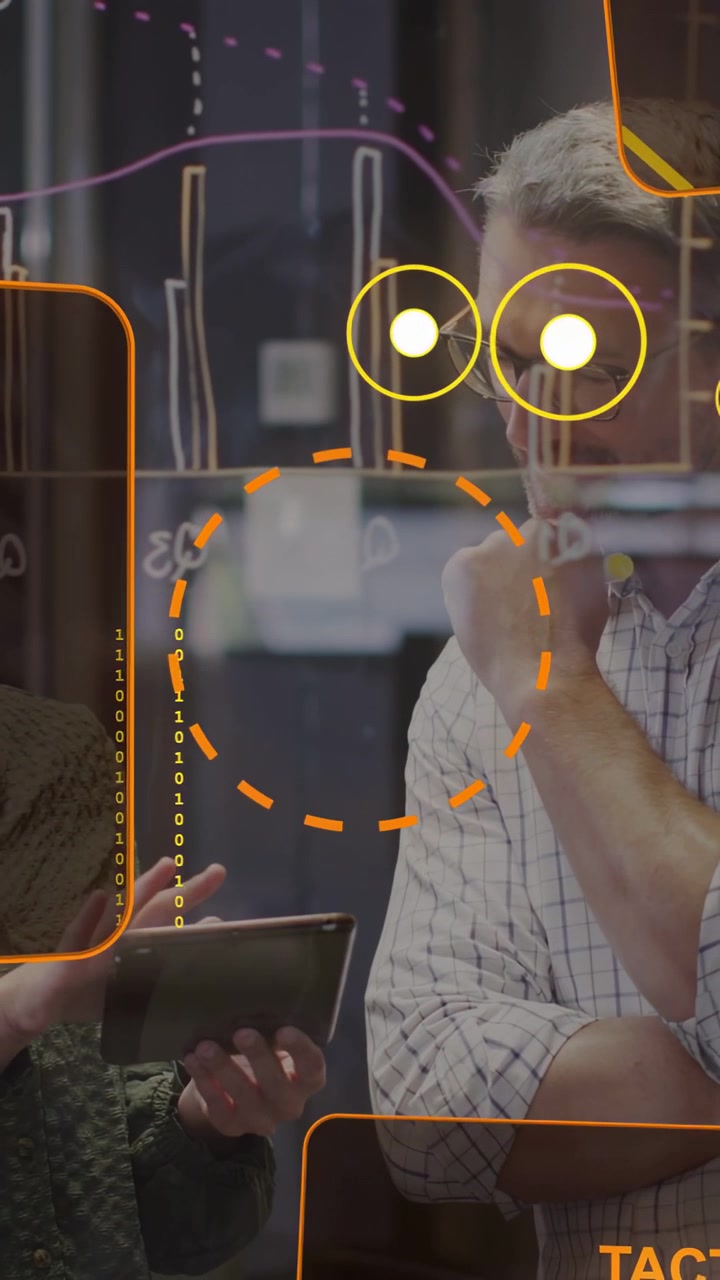 Vertical video: Pair reviewing tablet in tech woman tapping bringing orange HUD man deciding