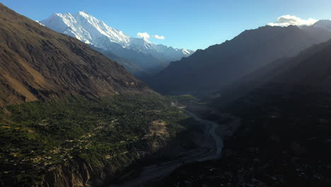 Cinematic-drone-shot-of-Tupopdan-Peak,-Passu-Cones-in-Hunza-Pakistan,-snow-covered-mountain-peaks-with-steep-cliffs,-high-wide-aerial-shot