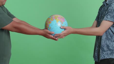 two people holding a globe