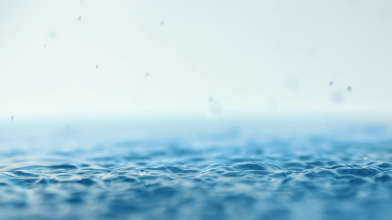 Rain water drops falling in super slow motion.