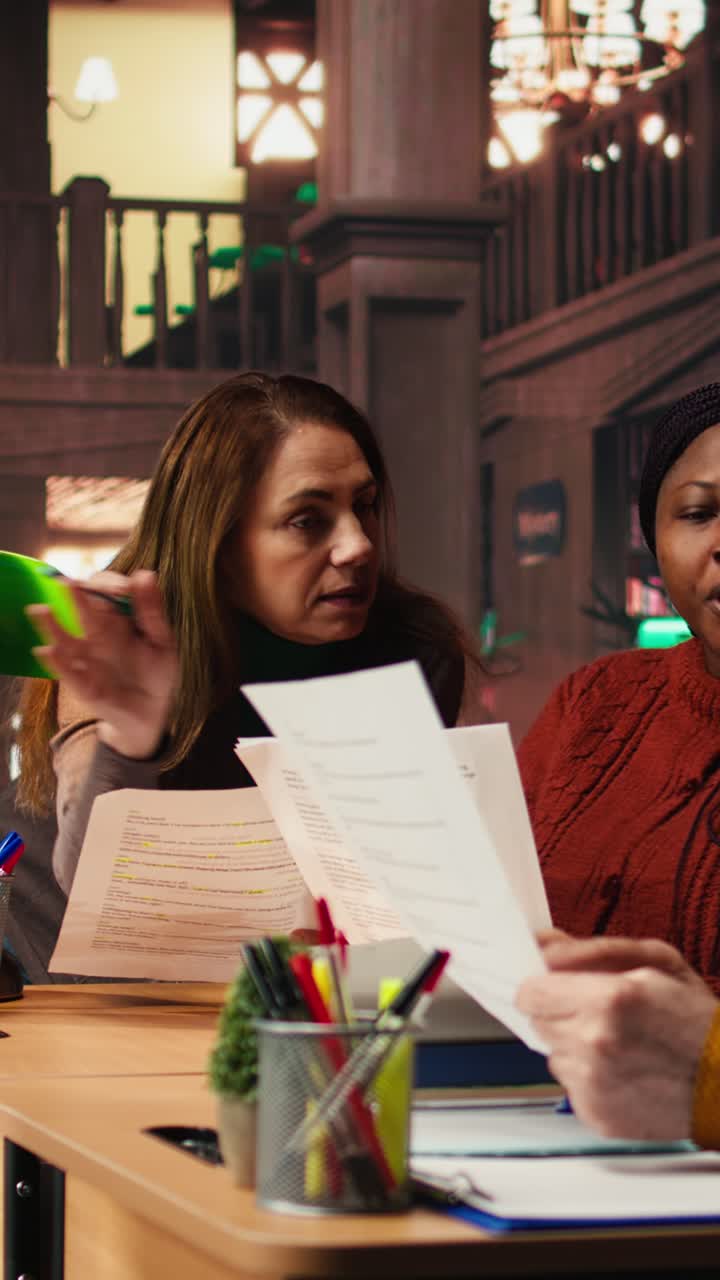 Vertical Video Mature team of performers rehearsing script dialogue together in a library