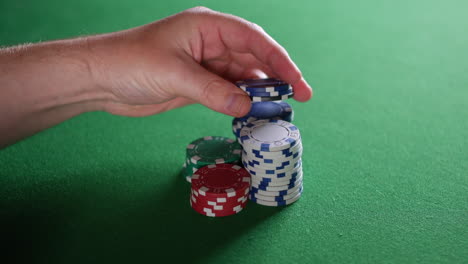 impatient man playing with poker chips in casino