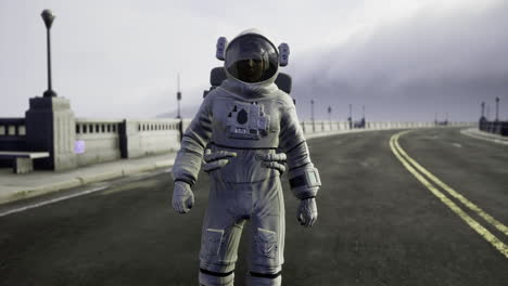 astronaut standing on deserted road under cloudy sky during afternoon