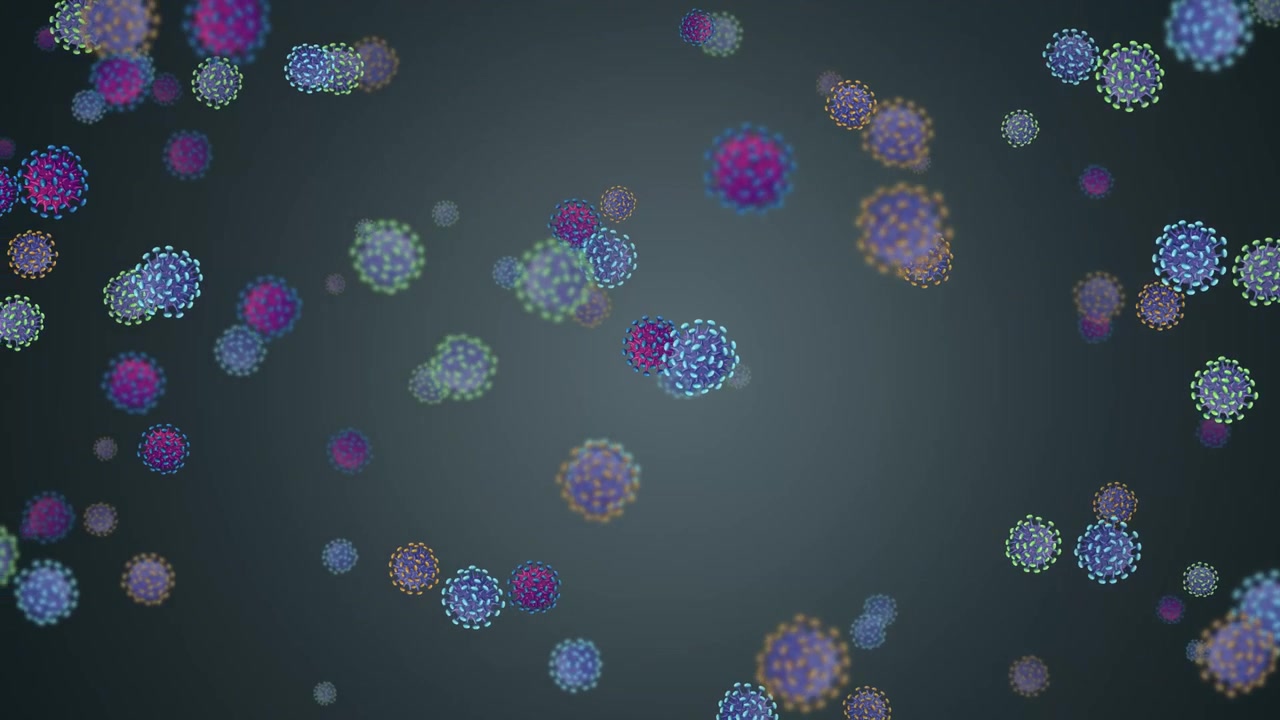 Cellule virali stilizzate e colorate fluttuano verso il basso in un'animazione al rallentatore con illuminazione soffusa
