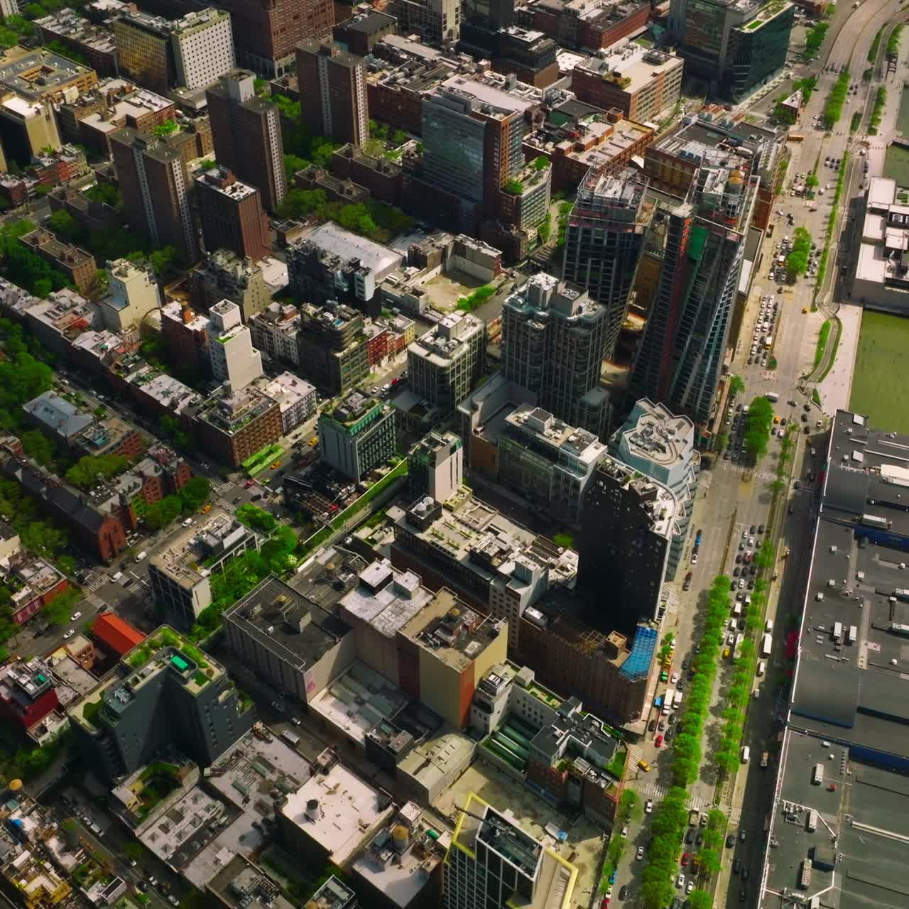 Beautiful quarters of Manhattan island near the river bank. Top view of the city with busy traffic