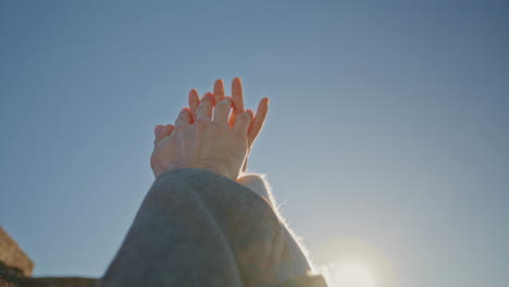 dating lovers crossing fingers on sky background closeup. couple touching palms