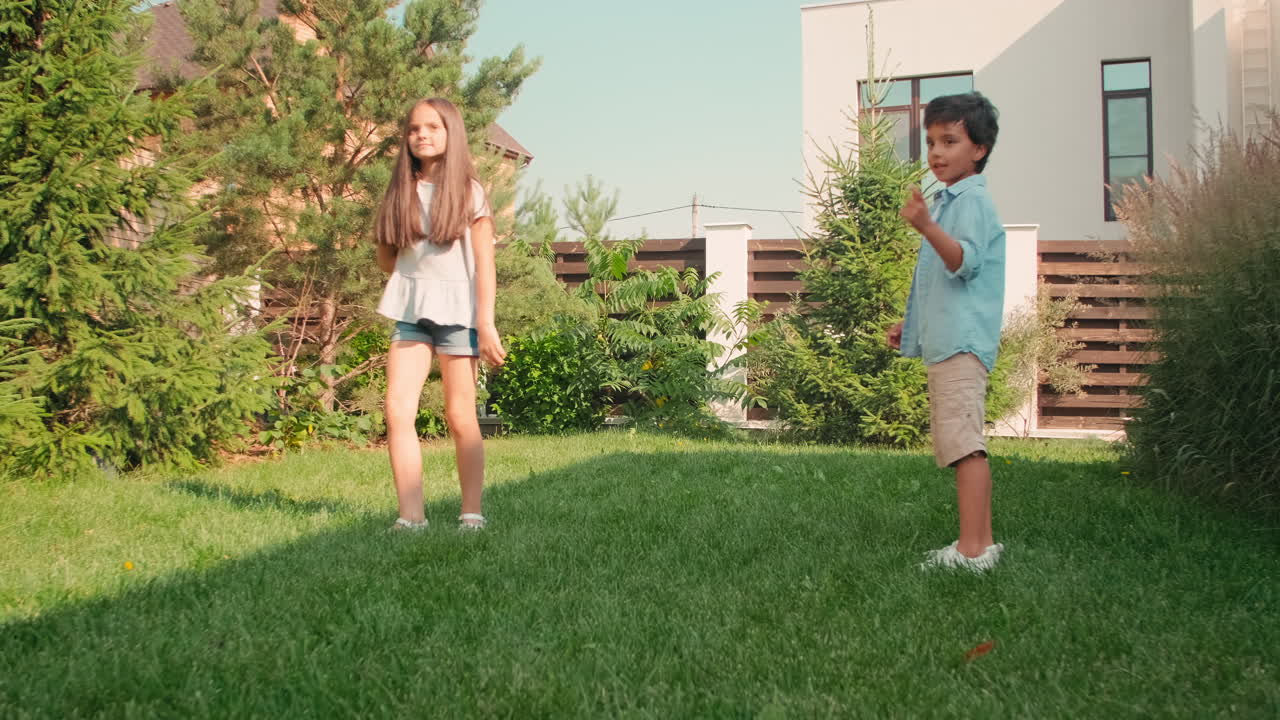 Cute Siblings Playing With Dog In Backyard