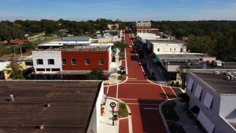 drone trucking pan from left to right above historic downtown clermont florida at midday