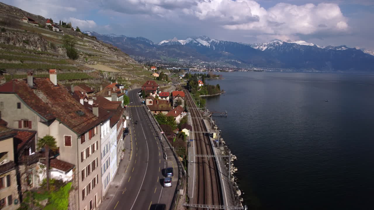 Drone fly above the train station of Rivaz and goes toward the lake Léman, Vevey, Montreux, in Switzerland