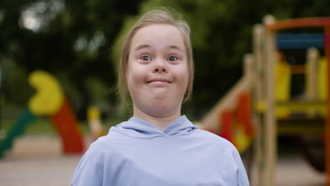 little girl with down syndrome looking at something with an astonished expression in the park