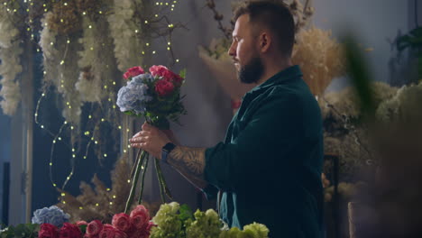 florist adds branches to beautiful flowers