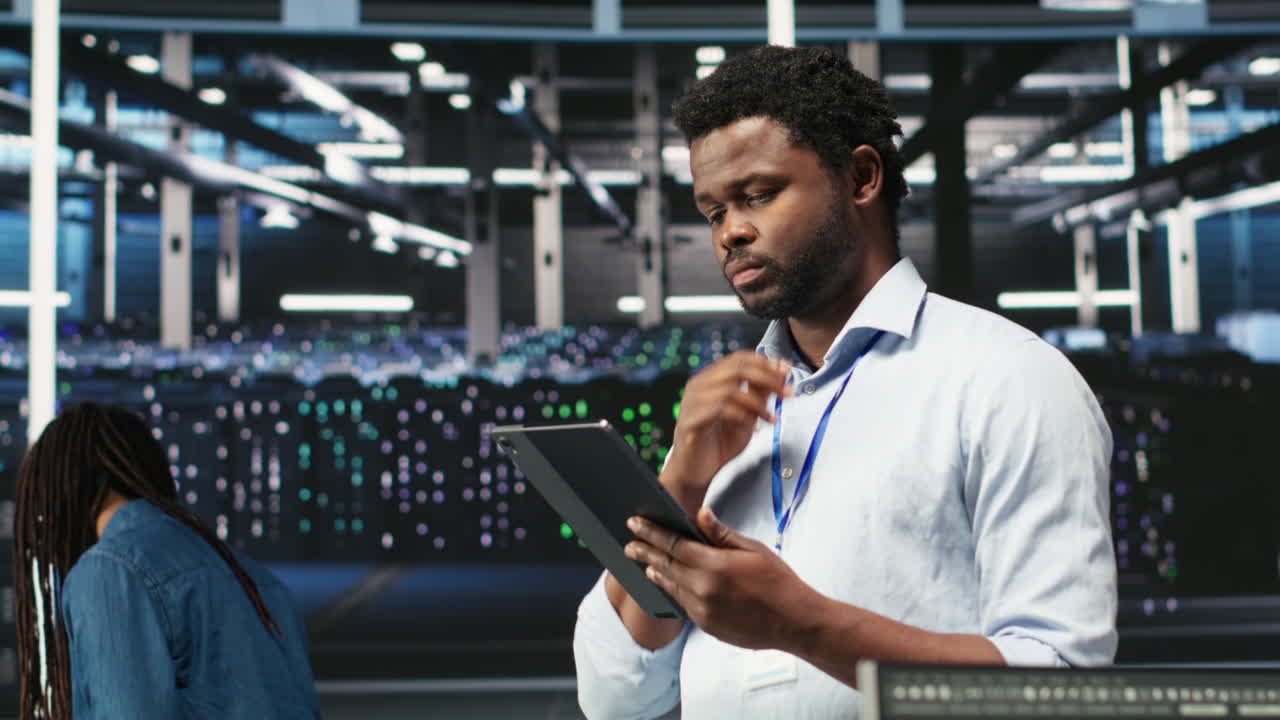 Data center engineer using tablet to interpret AI generated data analytics graphs
