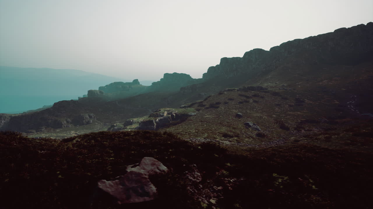 Views of rocky landscape under a hazy sky at twilight in mountainous region