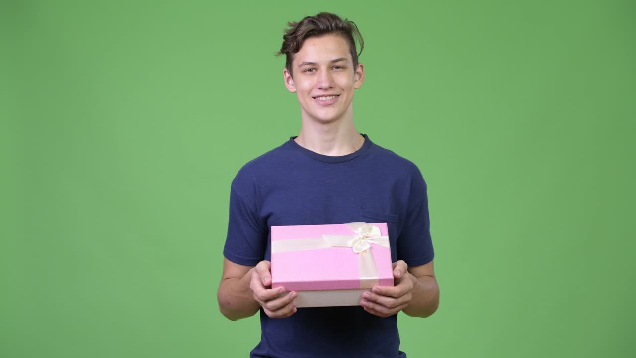 Young handsome teenage boy with gift box