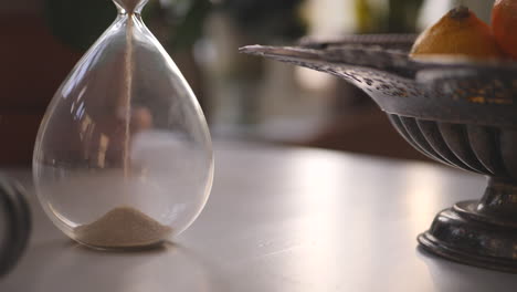 hourglass sand falling in slow motion cinematic paning