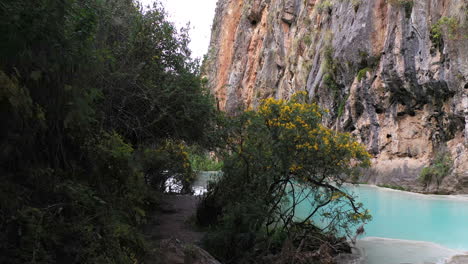 beautiful first person shot walking through the vegetation to reach the famous millpu lake of ayacucho peru with turquoise water