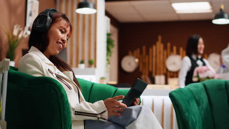 traveler using tablet to pass time in lounge area at hotel