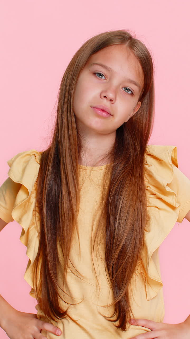 Child girl kid raising eyebrows in surprise showing gesture what why with puzzled emotional reaction