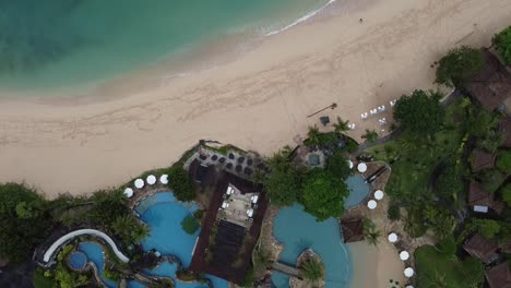 Aerial-view-fly-over-white-sand-and-lagoon-at-Nusa-Dua-Beach-Bali,-Indonesia