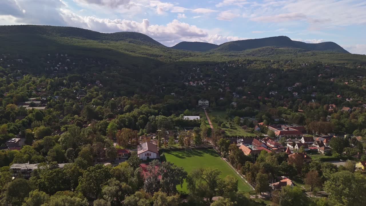 Orbital drone view of Leányfalu with its scattered houses in the forest of the Visegrád Mountains in Hungary
