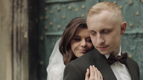 newlyweds, caucasian groom with bride walking, embracing, hugs in city, wedding couple in love