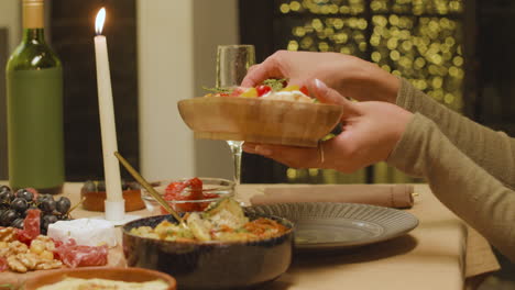 Woman-taking-food-from-plate