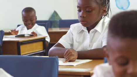 schoolgirl reading a book in an elementary school class