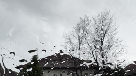 Raindrops-on-window-pane-surface-as-abstract-background