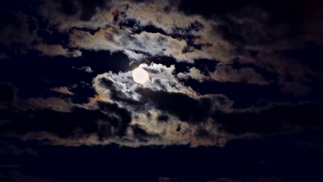 beautiful full moon and white clouds on black night sky