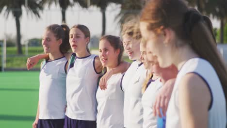 female hockey players standing in a row