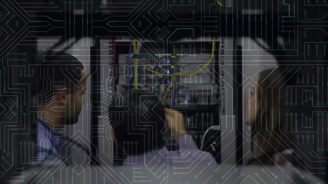People working on computer server while glowing motherboard moves in foreground