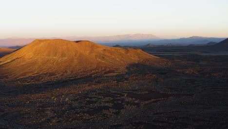 drone approaching cima volcanic field cinder cones craters in san bernardino county, california