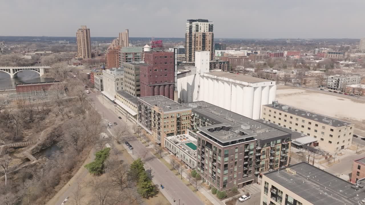 Drone footage of apartments and historic grain silos along St. Anthony Main, Minneapolis.