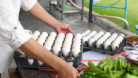 unloading crates of duck eggs on table in rustic setting