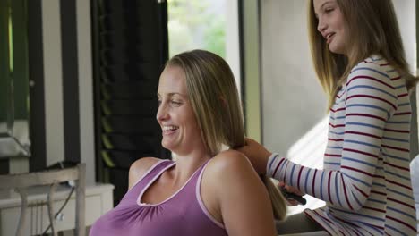 daughter brushing the hair of her mother