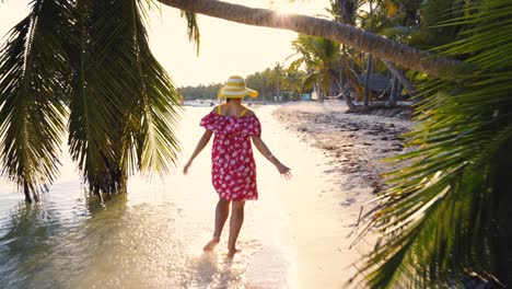 tropical sea sunrise and happy running woman enjoying morning sun on tropical island beach with palm trees