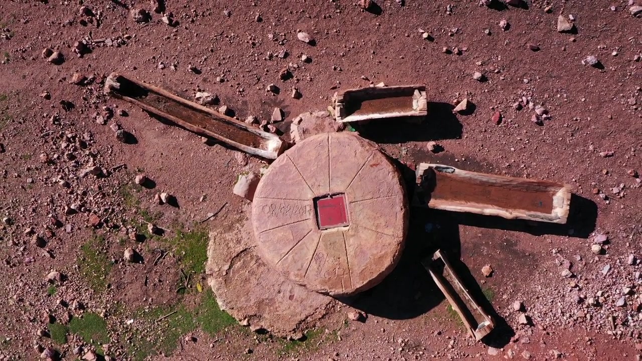 Top down aerial drone view of traditional circular stone structure on rocky terrain in the Middle Atlas Morocco ideal for documentary history and cultural projects