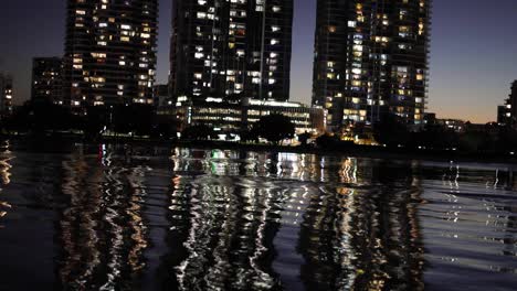 city lights reflecting on river at night