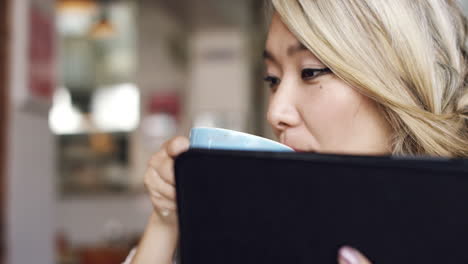 woman using tablet in coffee shop