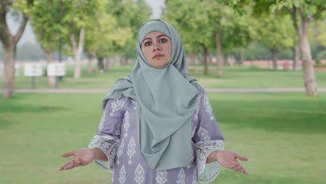 confused muslim woman asking what question in park