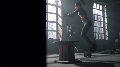 athlete jumping on wooden box. athletic woman doing fitness exercise