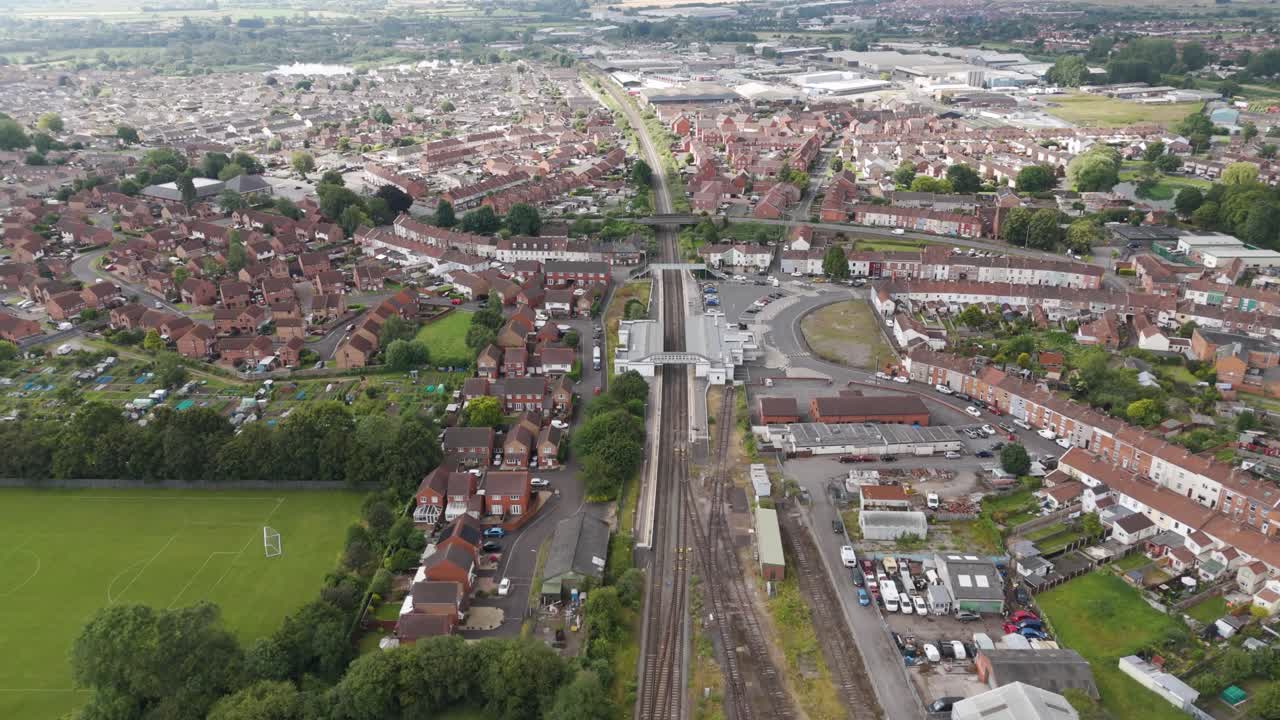 Aerial View of a Suburban Town with Railway Tracks and Residential Areas