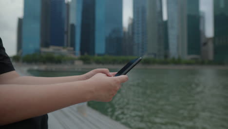 Person using smartphone in a city park