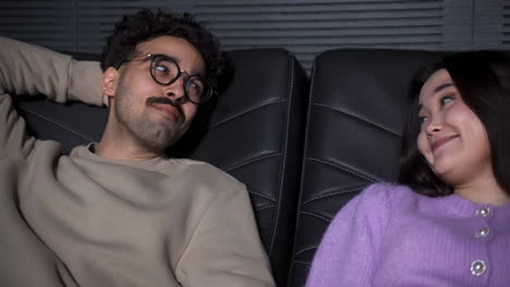 close-up view of a couple sitting in a vip cinema.