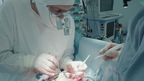 cardiothoracic surgeon performs surgery. doctor with nurse use endoscopic instruments during coronary artery bypass graft surgery in operating room