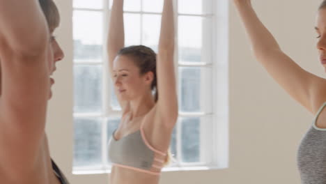 yoga class instructor teaching tree pose to beautiful group of women enjoying healthy lifestyle exercising in fitness studio meditation