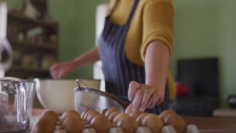 focused caucasian woman baking in kitchen