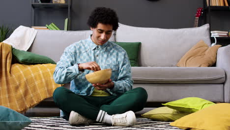 man eating chips in a bowl